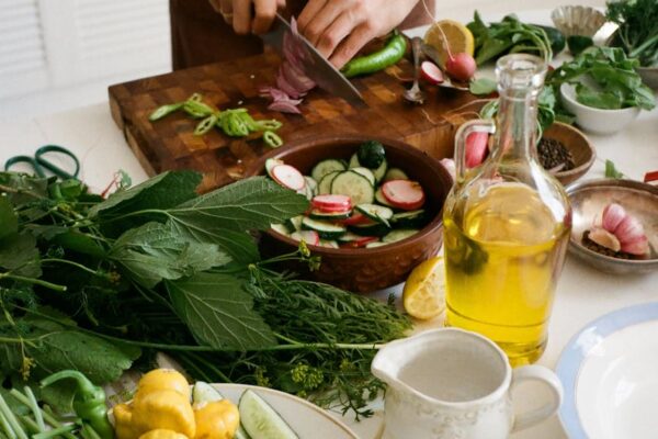 person slicing vegetables on chopping board