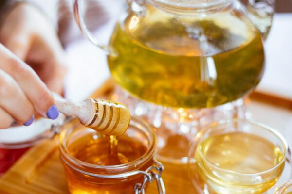 clear glass cup filled with honey